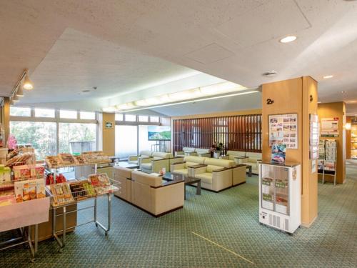 a store with couches and tables in a room at 河内長野荘 in Nagano