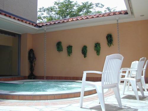 a patio with chairs and a swimming pool at Nara Plaza Hotel in Tenri
