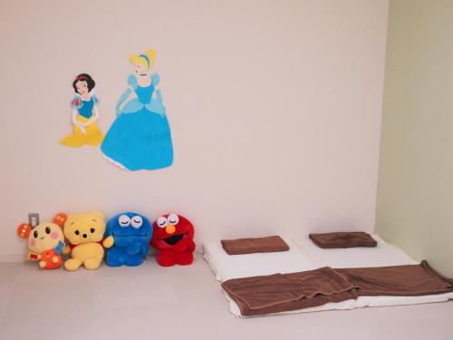 a bedroom with two beds and stuffed animals at Nara Plaza Hotel in Tenri