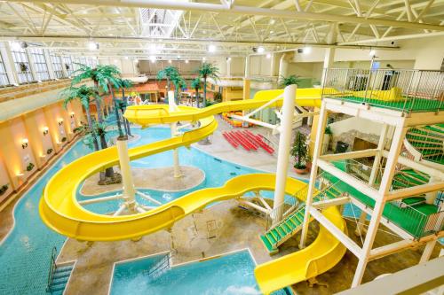 an indoor water park with a yellow water slide at Nara Plaza Hotel in Tenri