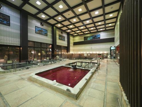a large building with a large pool of red water at Nara Plaza Hotel in Tenri