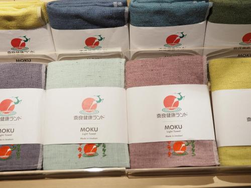 a pile of different colored towels on a shelf at Nara Plaza Hotel in Tenri