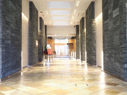 a hallway of a building with black brick walls at Nara Plaza Hotel in Tenri