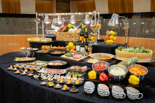 a buffet of food on a black table at Nara Plaza Hotel in Tenri