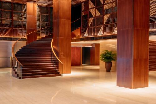 a staircase in a building with a potted plant at Grand Hyatt Singapore in Singapore