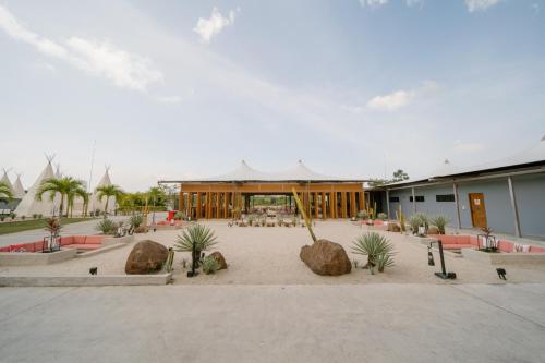 a building with a courtyard with plants and rocks at The ANMON Resort Bintan in Lagoi