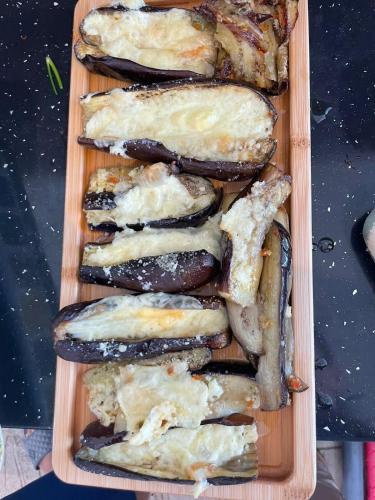 a wooden tray filled with different types of food at House Pollo in Ksamil