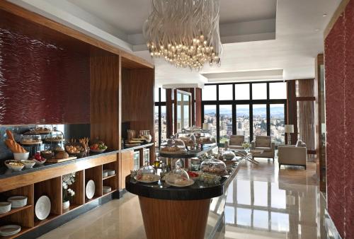 a dining room with a buffet with a chandelier at InterContinental Amman Jordan by IHG in Amman