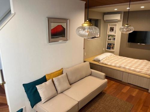 a living room with a couch and a bed at Honancho Entire house for rent 東京 in Tokyo