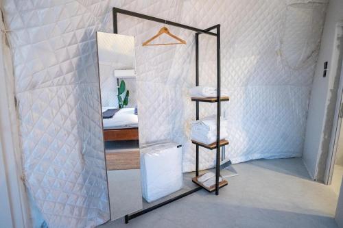 a mirror in a room with a bed at Starry Domes Desert Camp in Badīyah