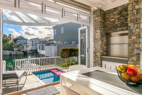a kitchen with a balcony with a view of the water at Turbine Villa in Knysna