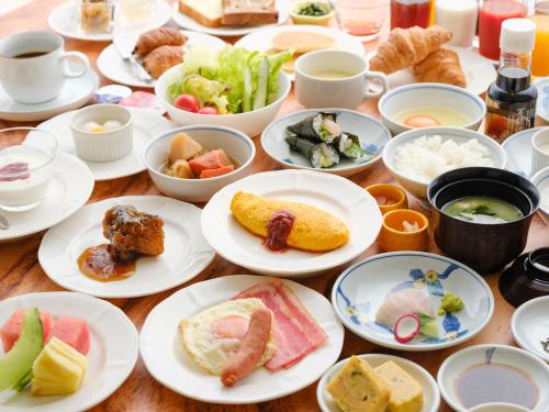a wooden table with plates of food on it at Inasayama Kanko Hotel in Nagasaki
