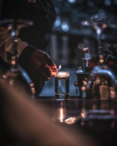 a man is preparing a drink at a bar at Elewana Arusha Coffee Lodge in Arusha