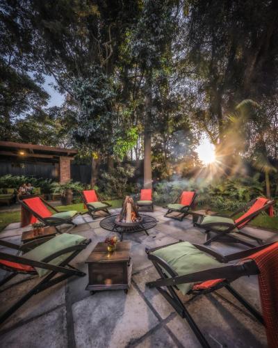 a patio with chairs and a fire pit at Elewana Arusha Coffee Lodge in Arusha