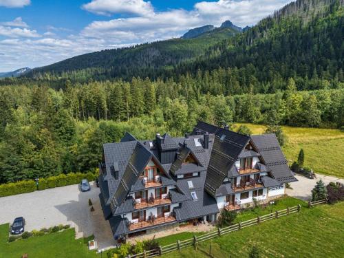 an aerial view of a house with solar panels at Hotel Eco Tatry Holiday& Spa in Kościelisko