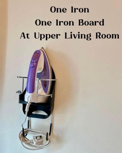 a iron on a iron board at upper living room at Entire home hosted by Catherine 4 bedroom House in Sandakan