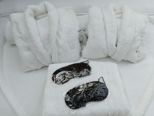two towels and two bags on a bed at Glamping Dôme in Cagnes-sur-Mer