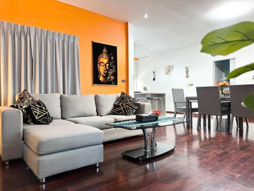 a living room with a couch and a table at Bangrak Cozy Stay in Koh Samui 