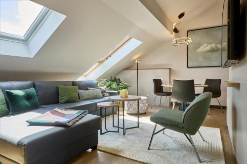 a living room with a couch and a table at June Six Hotel Hannover City in Hannover