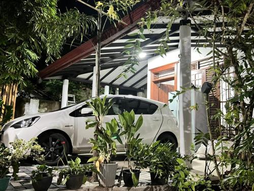 a white car parked in front of a house at Aqua Lina Villa in Matara