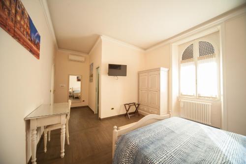 a room with a bed, a refrigerator, and a window at Villa Matissa in Rome
