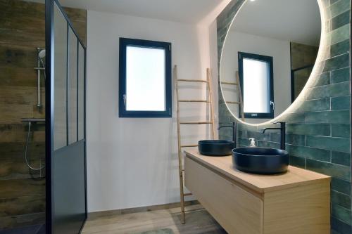 a bathroom with two sinks and a mirror at Cancale à la plage - Maison avec terrasse pour 6 in Cancale