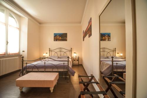 two twin beds in a room with a mirror at Villa Matissa in Rome