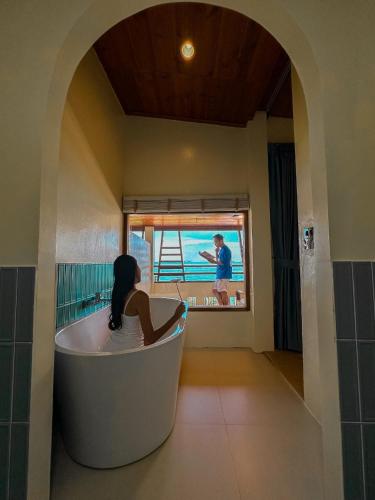 a woman sitting in a bath tub in a room at Samed Seaside Resort in Ko Samed