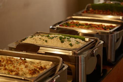 a group of five trays of pizzas on a table at Pegasus Reef - A Beach Resort in Colombo in Colombo