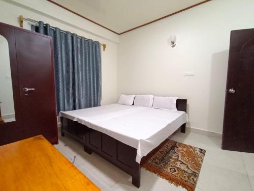 a bedroom with a bed in a room at SK Guest House in Shillong