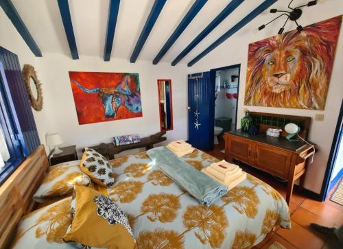 a bedroom with a bed and a painting of a lion at Sondela Self Catering in São Martinho do Porto