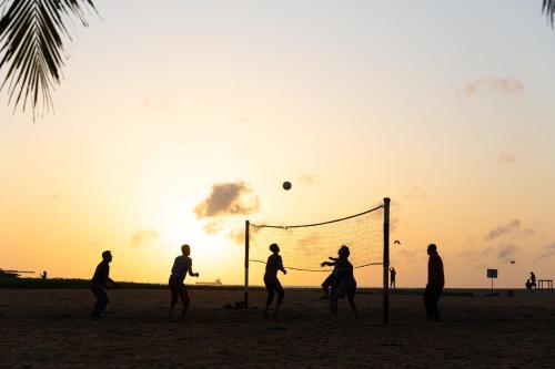 a group of people playing soccer on the beach at Pegasus Reef - A Beach Resort in Colombo in Colombo