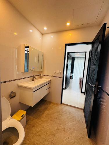 a bathroom with a toilet and a sink and a mirror at Seaview Prima Villa Karon beach in Karon Beach
