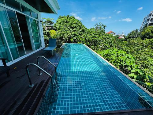 a swimming pool on the deck of a house at Seaview Prima Villa Karon beach in Karon Beach