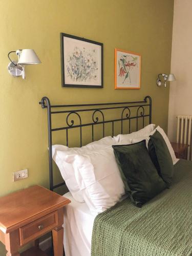 a bedroom with a bed and a table with a night stand at Hotel Antica Stallera in Cannobio