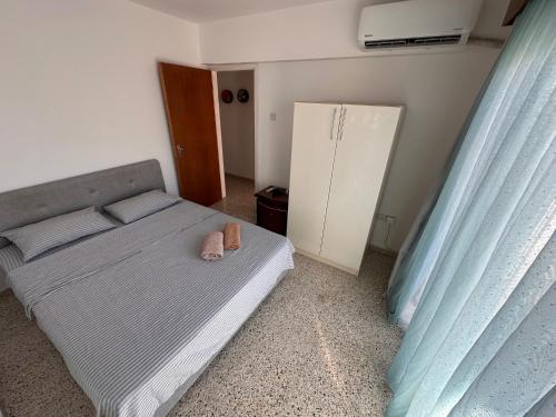a bedroom with a bed with a pair of shoes on it at 3 bedroom apartment opposite Kyrenia harbor in Kérynia