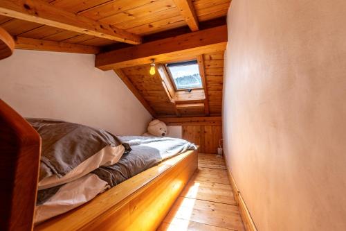 a bedroom in a log cabin with a bed at Chalet le Persan Courchevel 10 pl in Courchevel