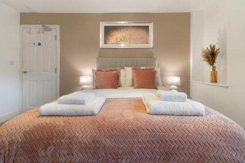 a bedroom with a large bed with two pillows on it at WhiskAwayStays - Jenkins House - Apartment 1 in Worcester