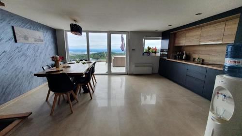 a kitchen and dining room with a table and chairs at Villa Melani **** in Oriovac