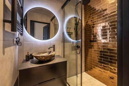 a bathroom with a sink and a mirror at Luxury Watervilla Near Amsterdam And Schiphol in Aalsmeer