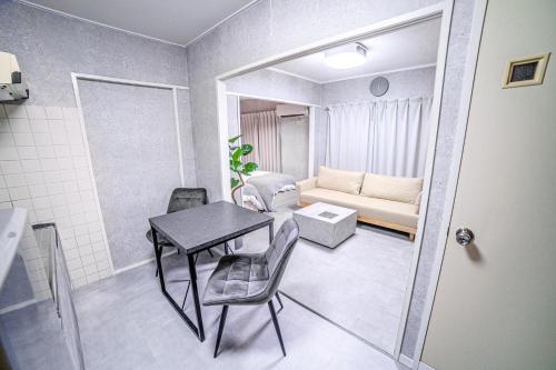 a small living room with a table and a couch at 1 line to Asakusa! Projector, 5 mins walk from Togoshi-ginza Sta in Tokyo