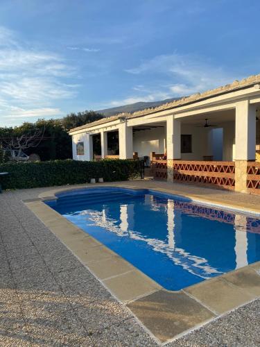a swimming pool in front of a house at Casa María in Órgiva