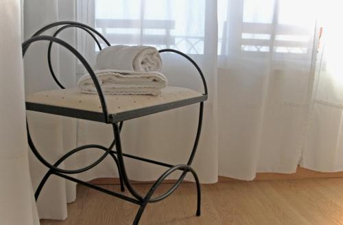 a towel rack with towels on it next to a window at Apartamentos Bahía Alicante in Alicante