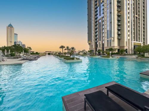 a large swimming pool in a city with tall buildings at Luxury Apt in Business Bay Water canal view in Dubai
