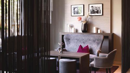 a room with a desk and a chair and a table at City Hotel Merano in Merano