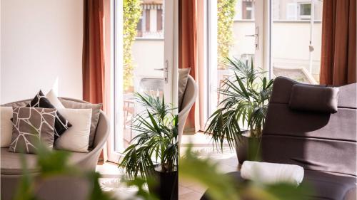 a living room with a chair and a window at City Hotel Merano in Merano