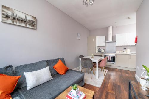 a living room with a couch and a table at Watford Junction 2 bedrooms Apartment, Free,Parking, Warner Bro nearby -15 mins to Central London in Watford