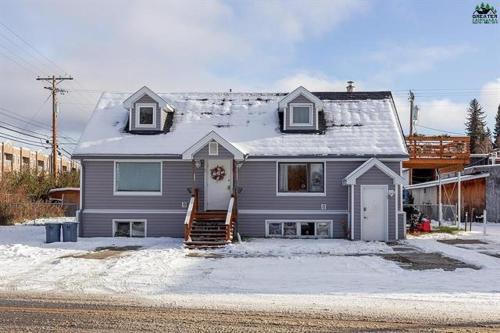 a gray house with a snow covered roof at Fairbanks Great Location in Fairbanks