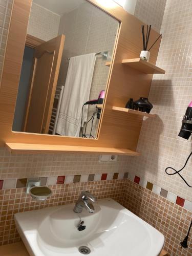 a bathroom with a sink and a mirror at Hostal Don Santiago Ramon y Cajal in Petilla de Aragón