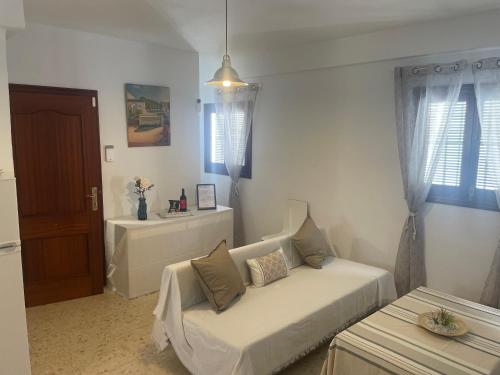 a living room with a bed and a couch at Apartamentos Lucero de Europa in Carmona